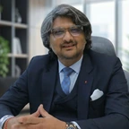 Nikhil Parikh, founder and MD of FinDesk, in a three-piece suit at his desk